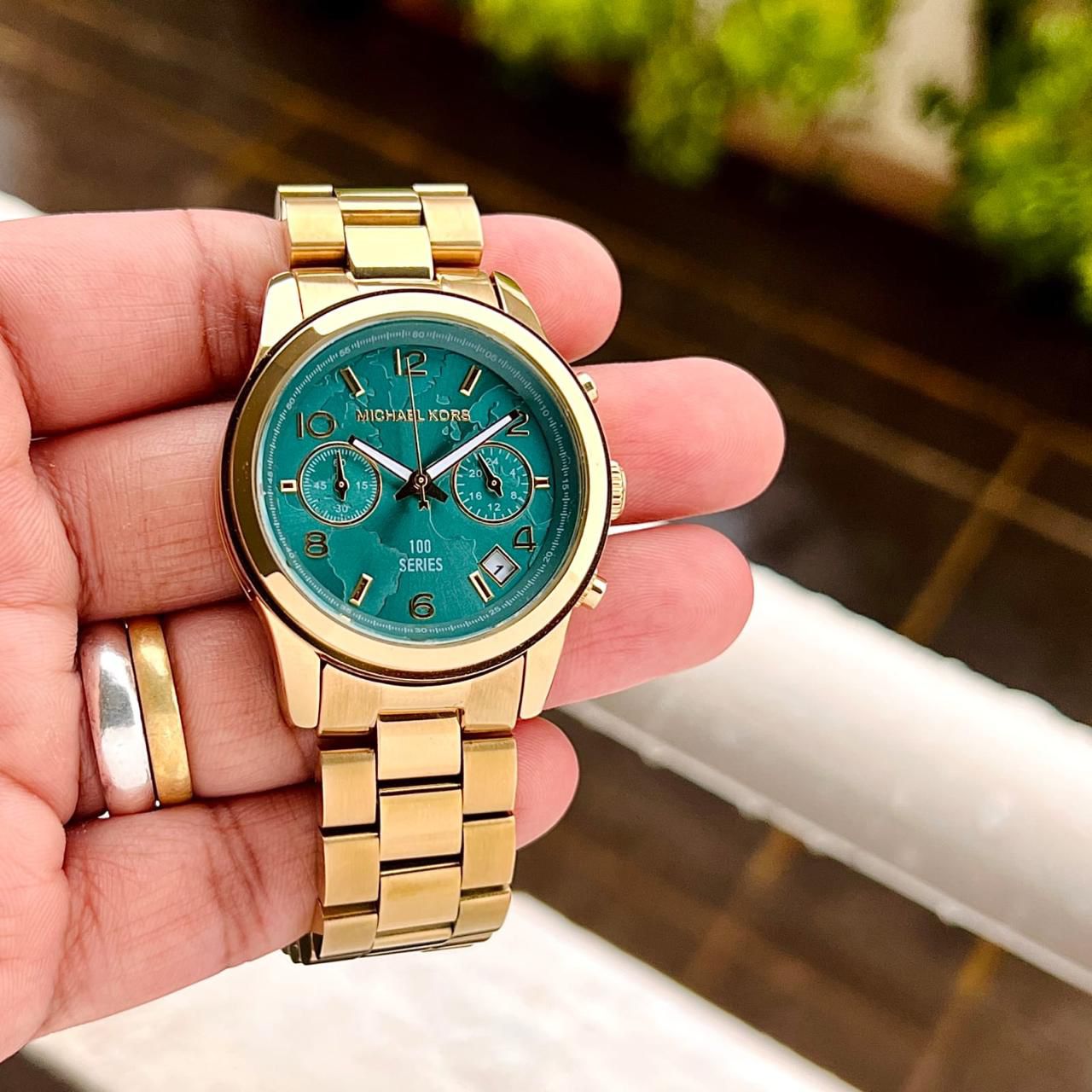 Michael Kors MK5815 watch with a PVD gold plated case and turquoise coloured dial maurya watch